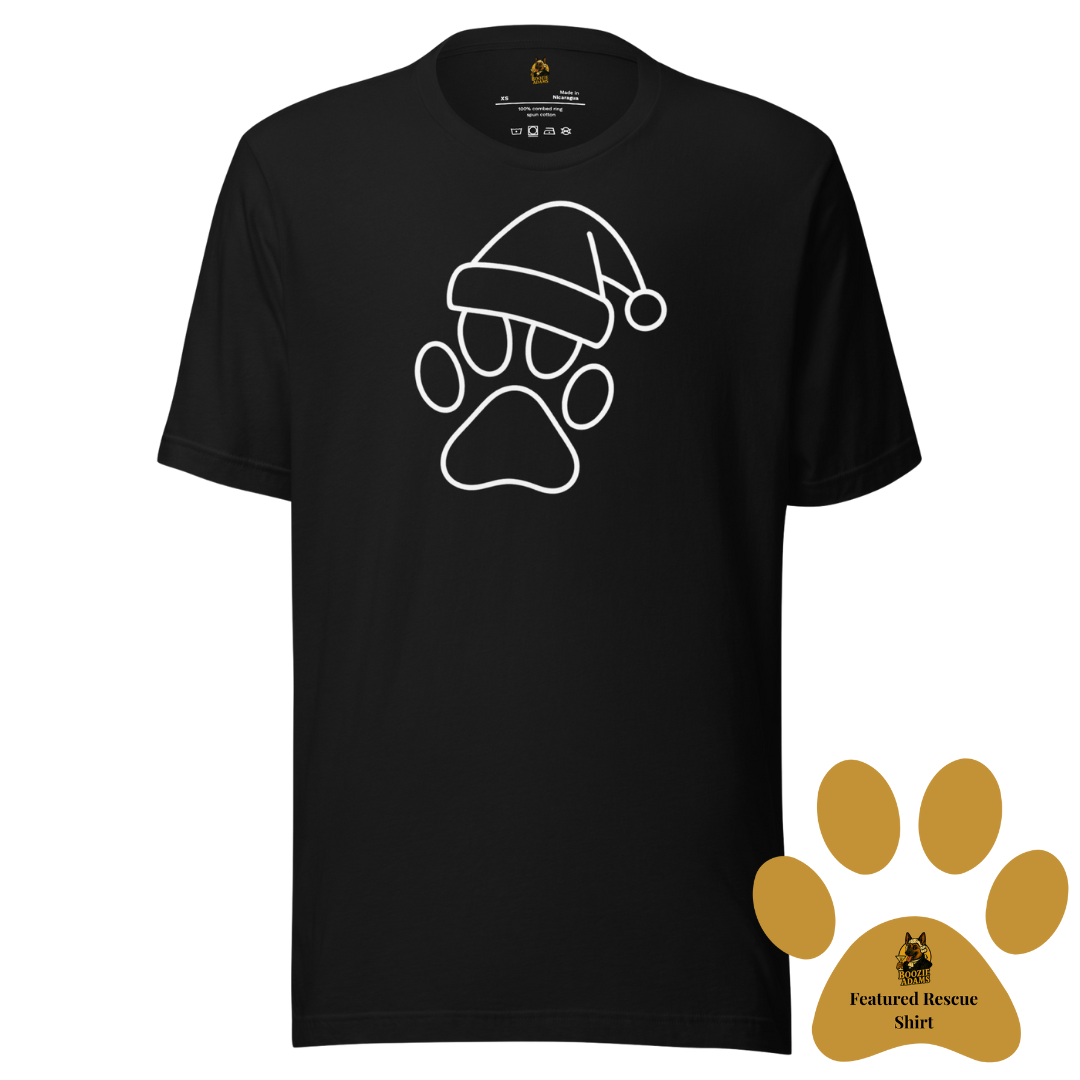 Black unisex t-shirt with a white paw print wearing a Santa hat design. A gold paw in the corner of the image symbolizes this is the current Boozie Adams Featured Rescue Shirt – Boozie Adams