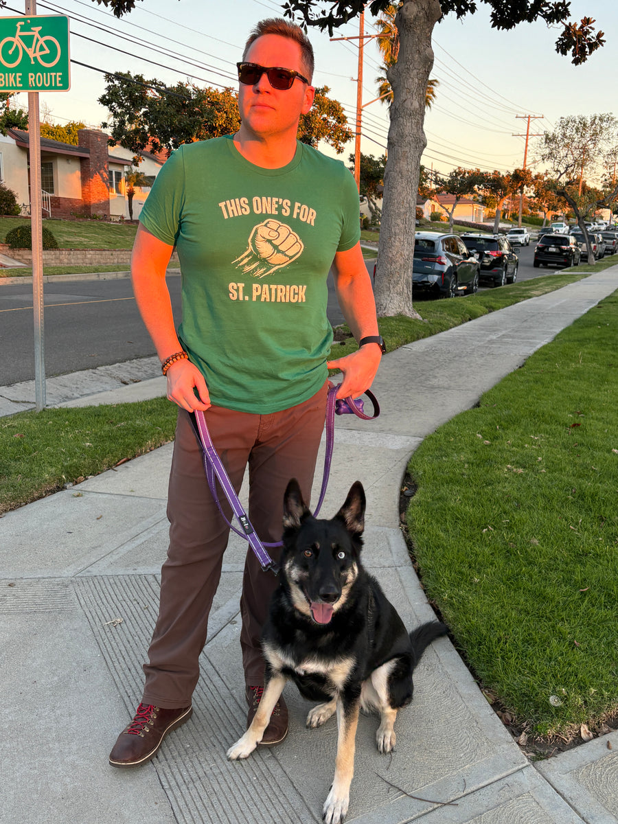 Customer wearing Boozie Adams This One's for St. Patrick tee while walking a dog