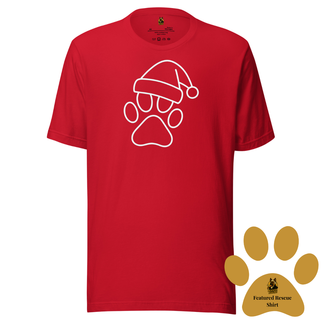 Red unisex t-shirt with a white paw print wearing a Santa hat design. A gold paw in the corner of the image symbolizes this is the current Boozie Adams Featured Rescue Shirt – Boozie Adams