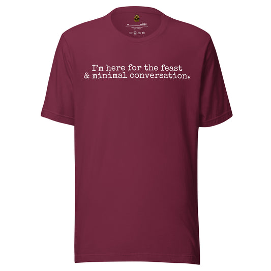 Maroon unisex t-shirt with white text 'I'm here for the feast & minimal converstion' – Boozie Adams